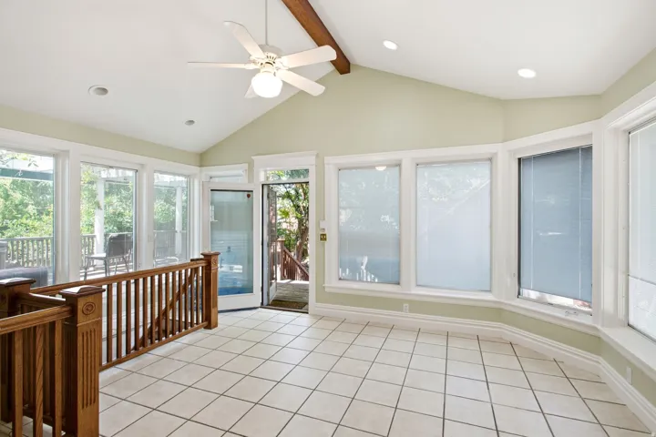 Room featuring a vaulted ceiling with exposed beam, ceiling fan, and recessed lighting