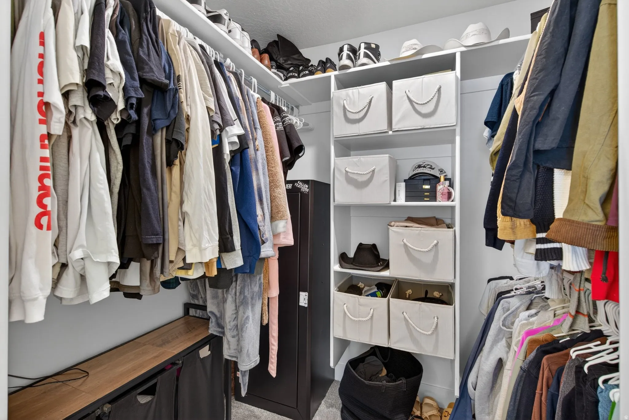Custom closet system featuring white shelving and multiple hanging rods for organization