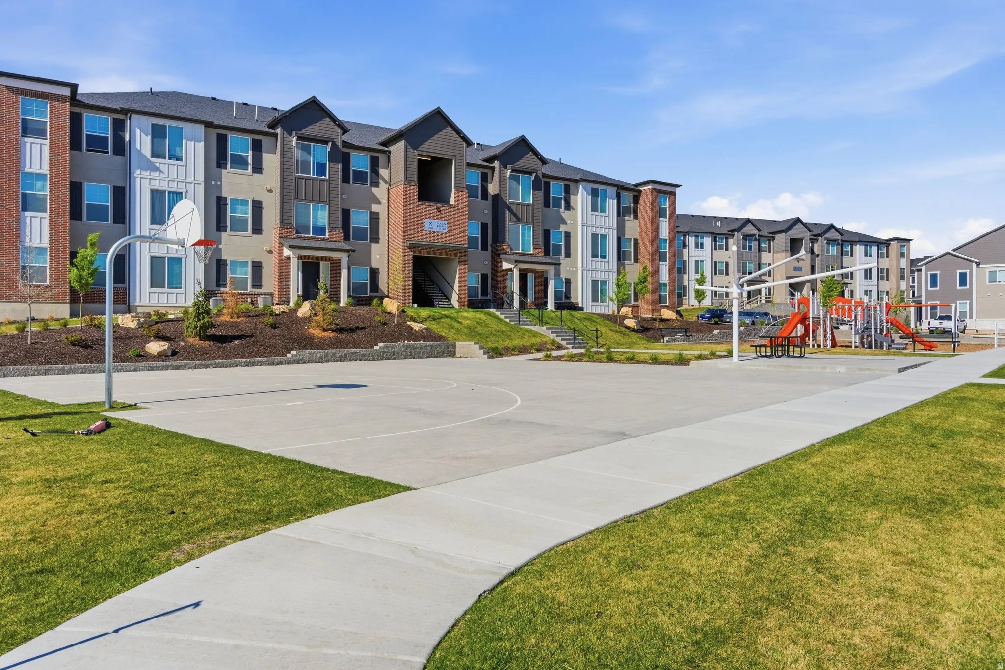 Expansive concrete play court with a basketball hoop
