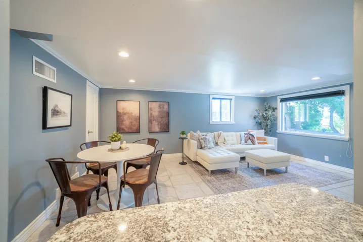 Open concept living space with recessed lighting and crown molding