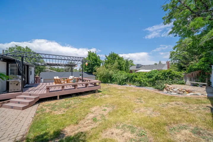 Spacious outdoor deck with a metal pergola structure