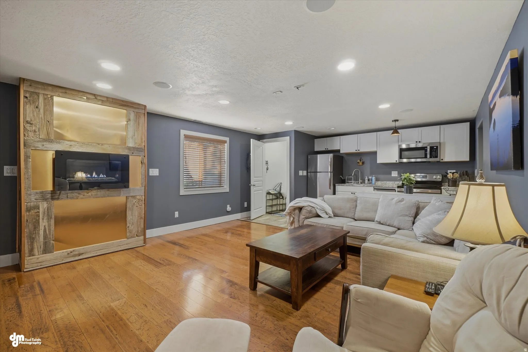 Open-concept living space with wood-finish flooring