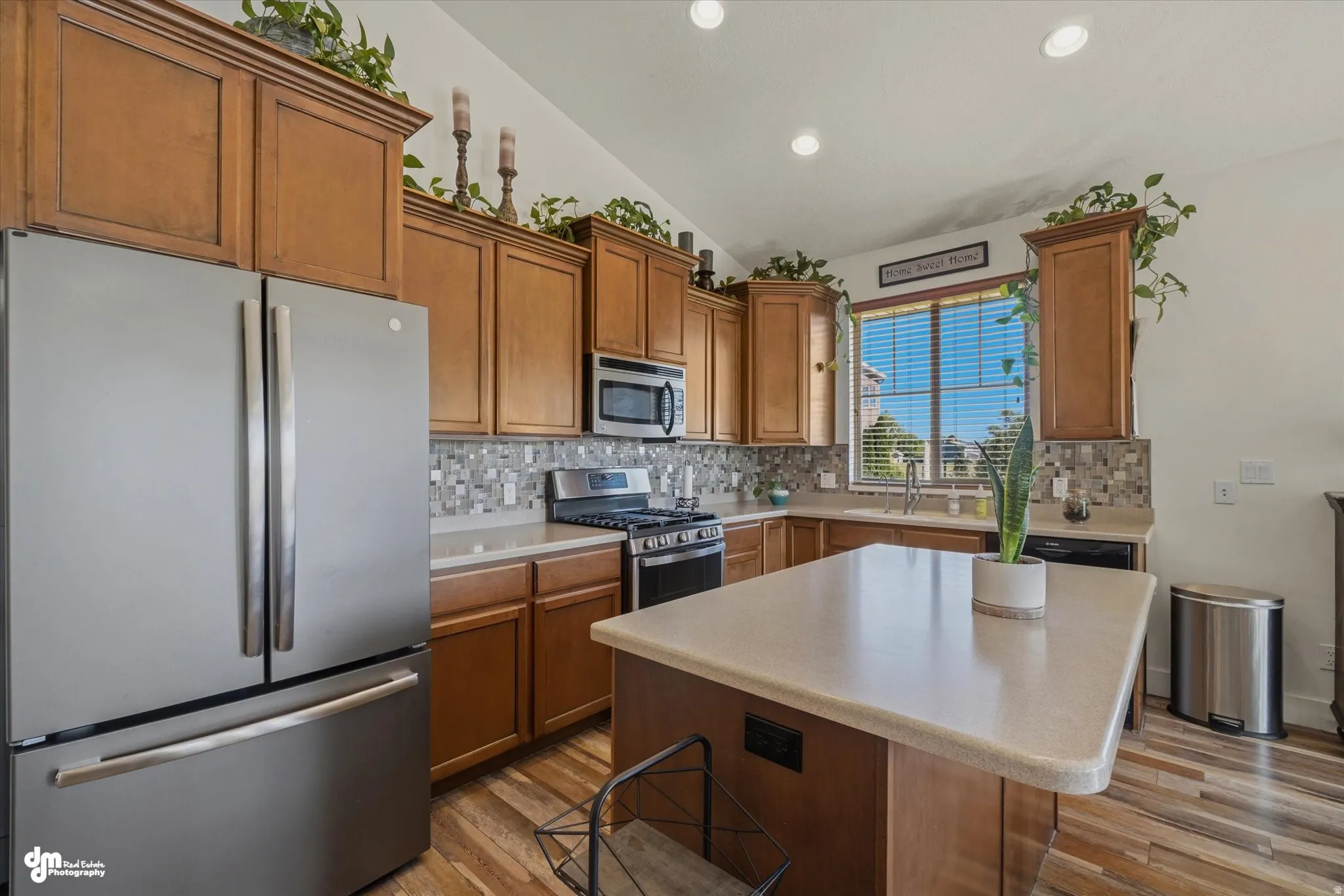 Kitchen featuring wood-finish flooring, recessed lighting, and a vaulted ceiling
