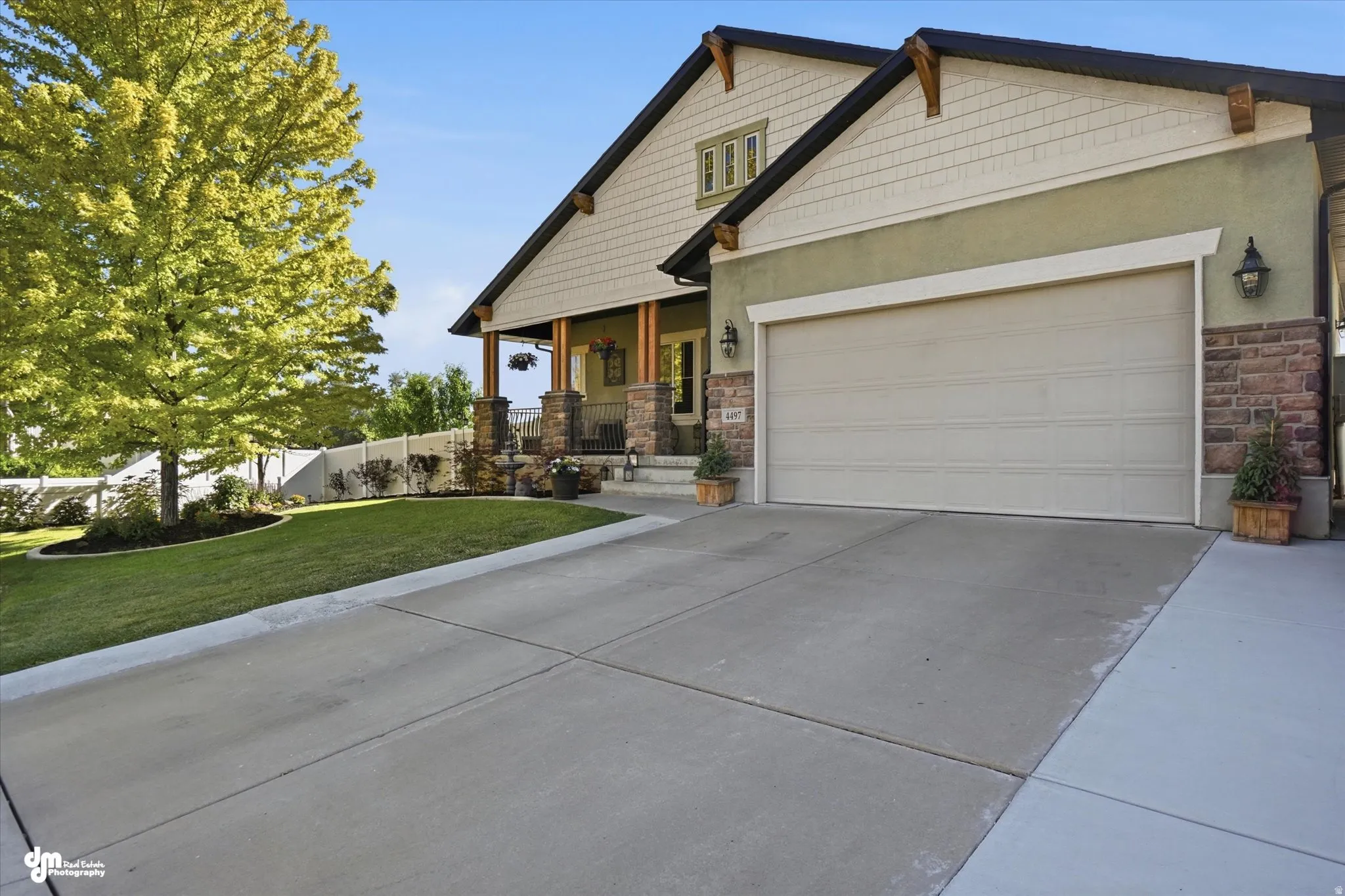 Front exterior featuring a concrete driveway, attached two-car garage, and a covered porch entry