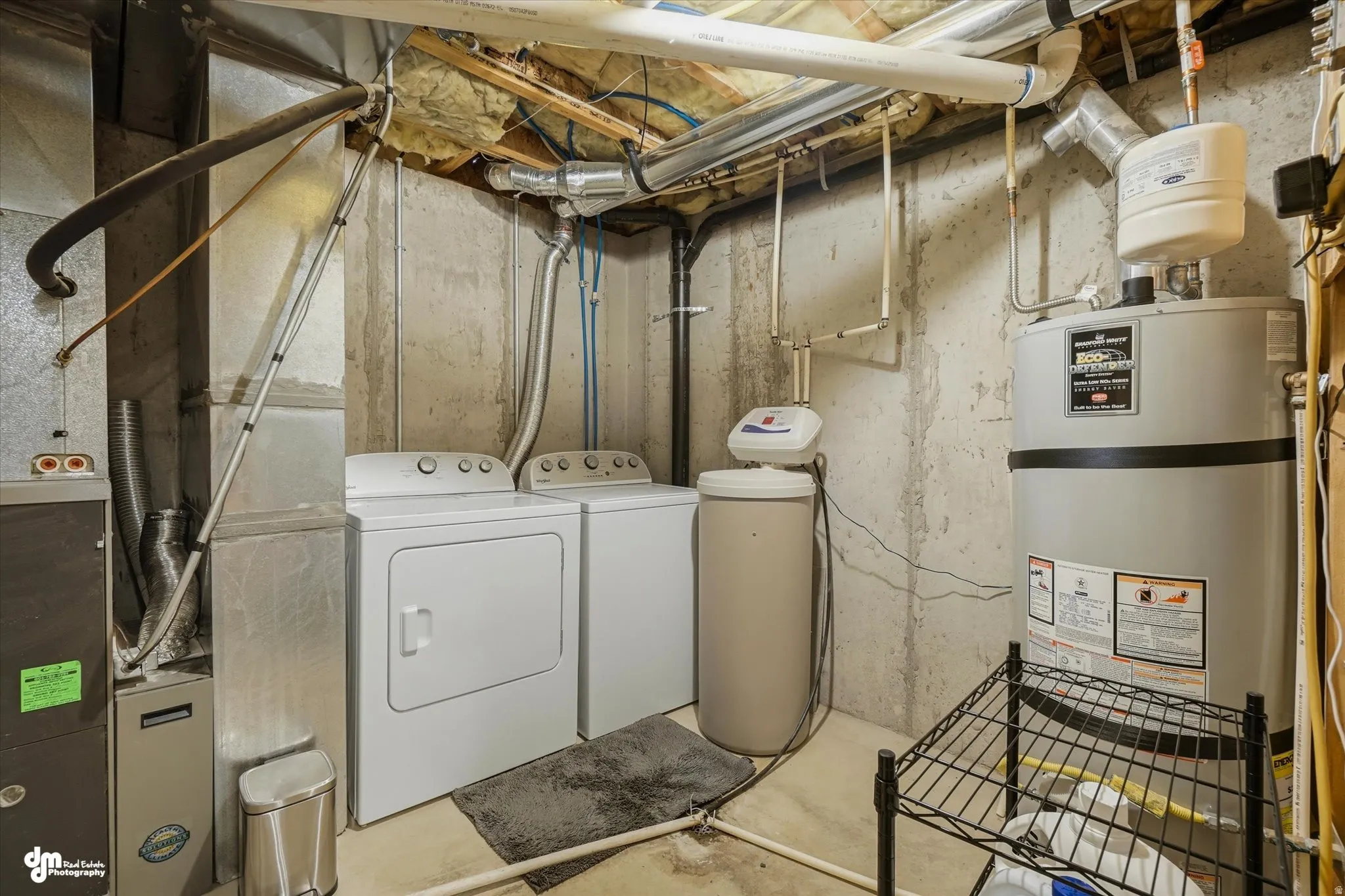 Utility area featuring a furnace, water heater, water softener, and laundry appliances