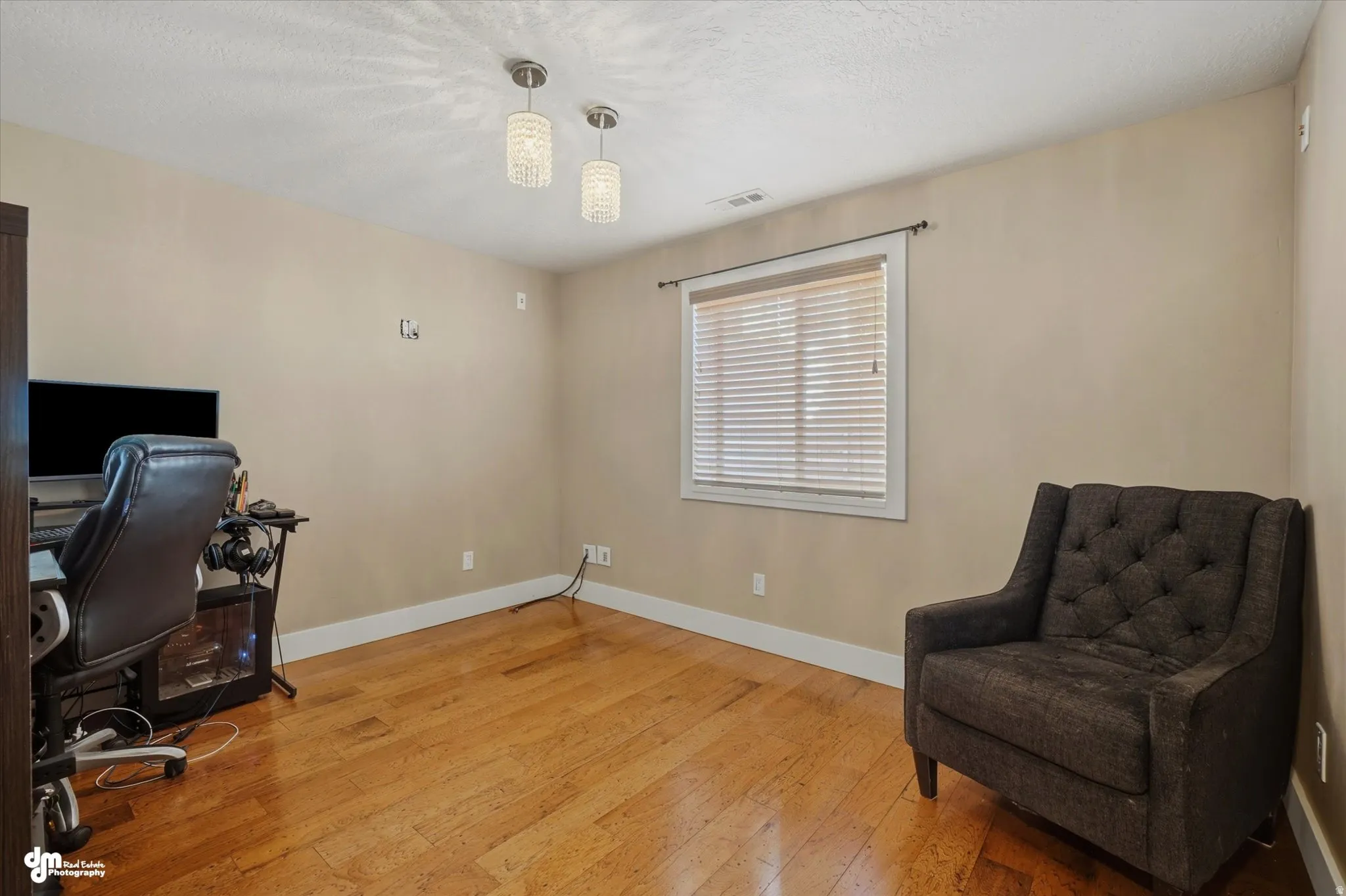 Interior room featuring wood-finish flooring, neutral wall tones, and white baseboards
