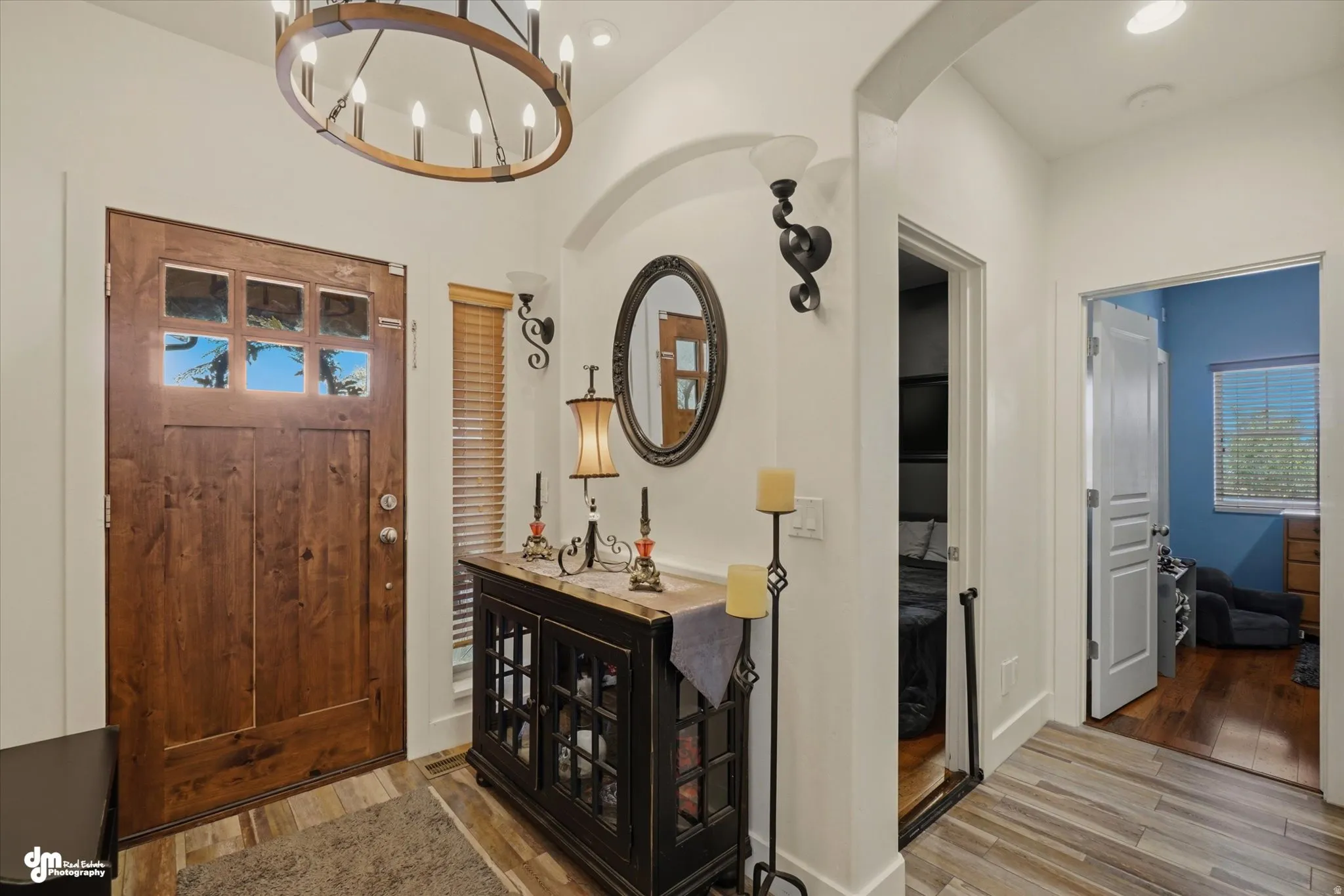 Entryway featuring a wood-finish front door with glass lites, a circular chandelier, and wood-finish flooring