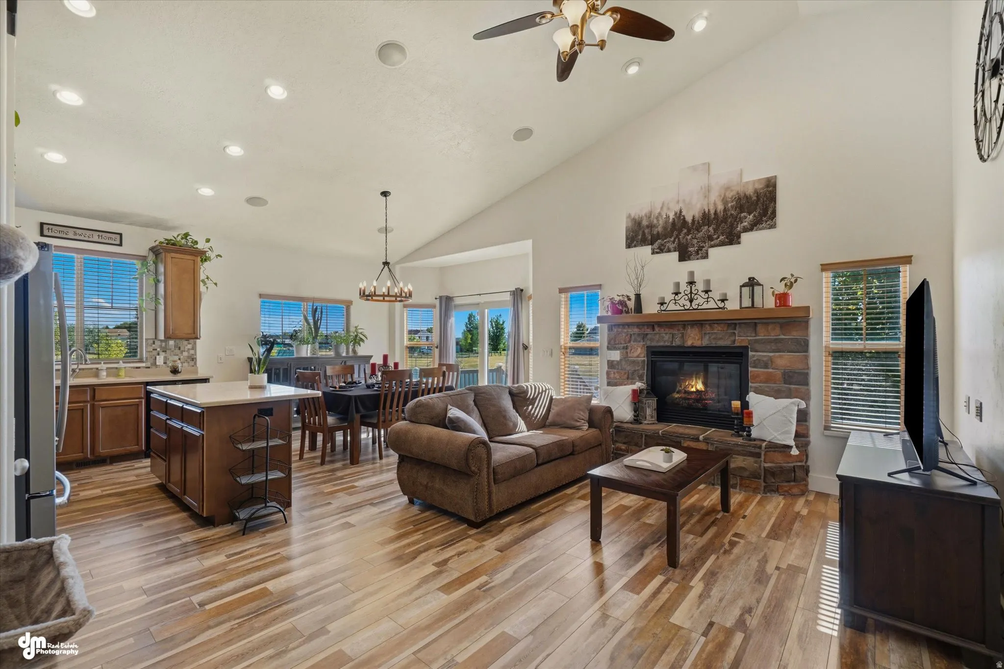 Vaulted ceilings highlight the open-concept living space with wood-finish flooring