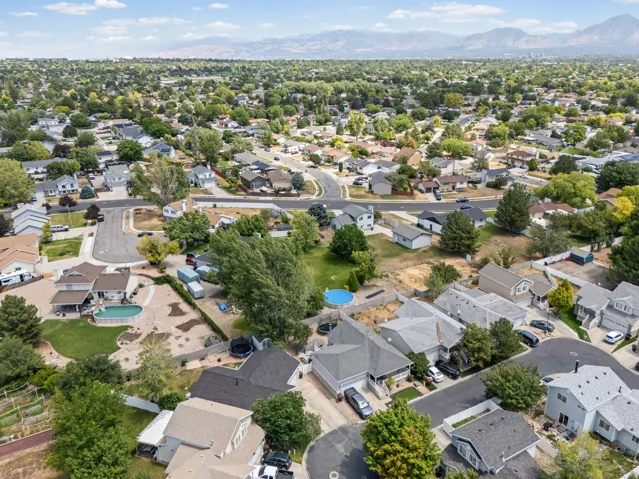 Aerial perspective showcasing a residential neighborhood with varied architectural styles and mature landscaping