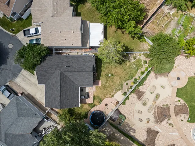 Property featuring a multi-textured yard with defined garden beds and paved pathways