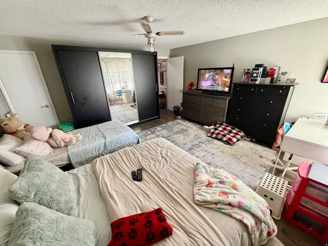 Spacious room featuring wood-finish flooring and light-toned wall paint