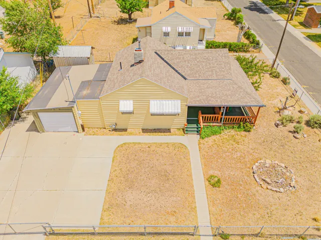 Single-story residence featuring a shingle roof, covered front porch, and an attached garage