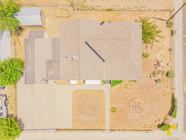 Single-story residence featuring a shingled roof and concrete driveway