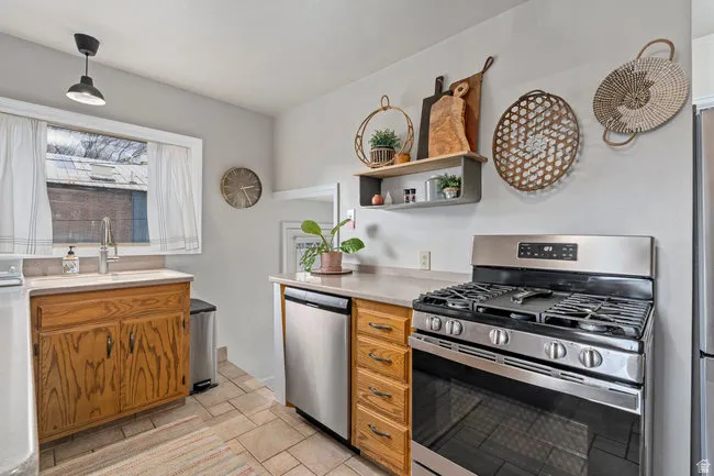 Kitchen featuring a stainless steel gas range and dishwasher