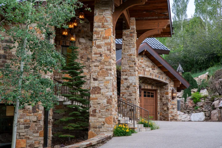 Stone exterior with exposed wood beam accents