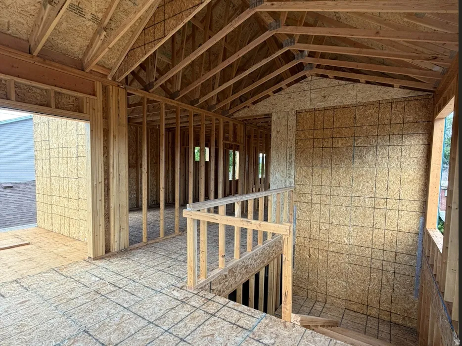 Top of stairs loft with large windows, vaulted ceilings and balcony access.