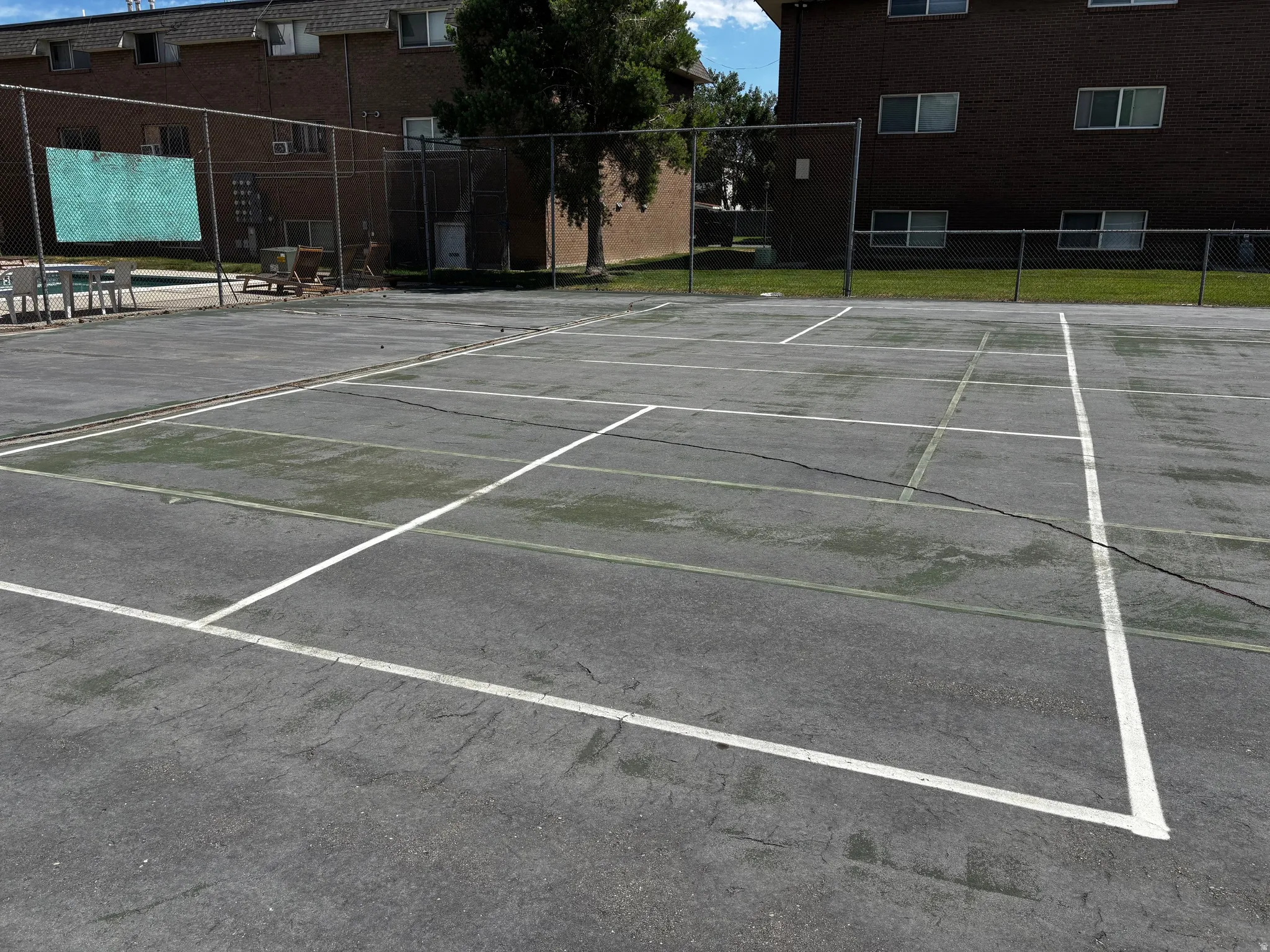 Large cement area with tennis, basketball and pickleball opportunities