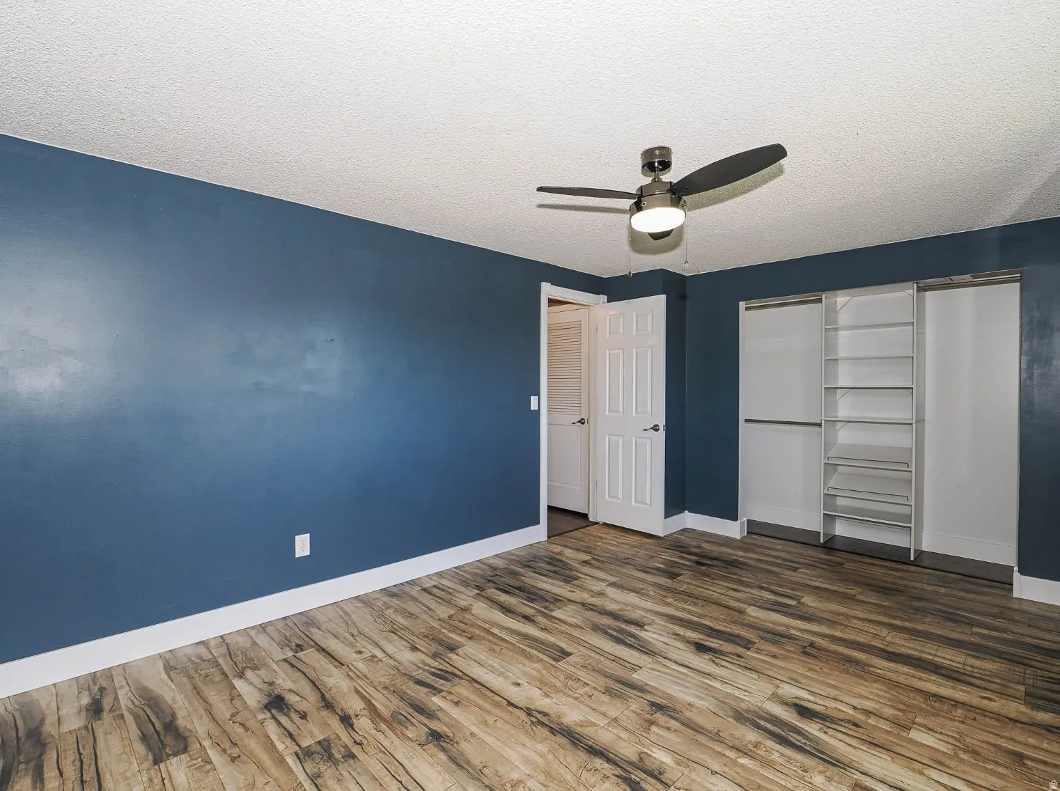 LVP flooring  and organized closet in bedroom