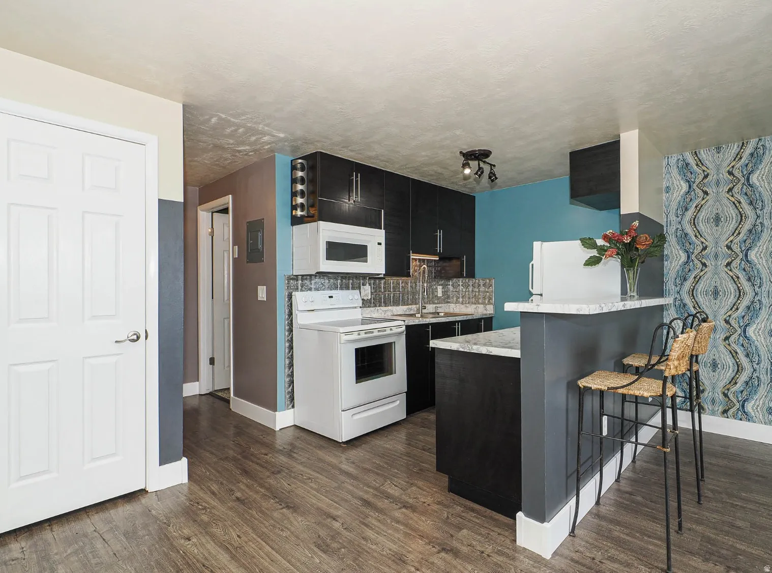 Kitchen with dining bar not found in other units. Bar stools included!