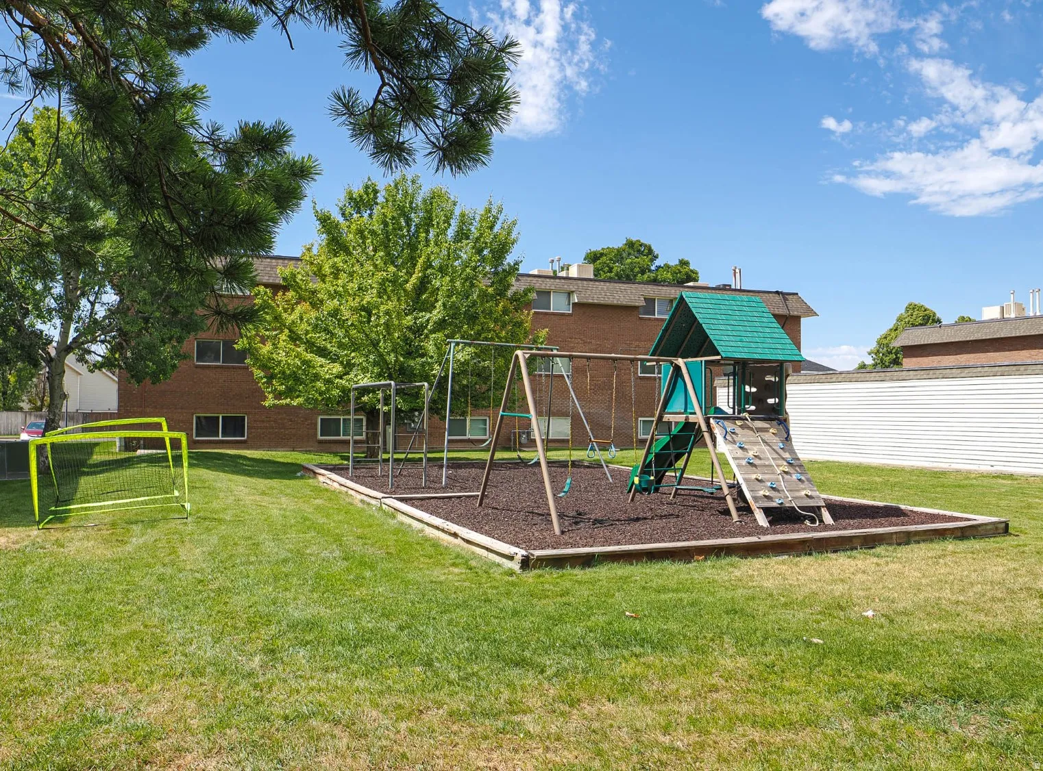 Outdoor play area with shade and rubber mulch for safety