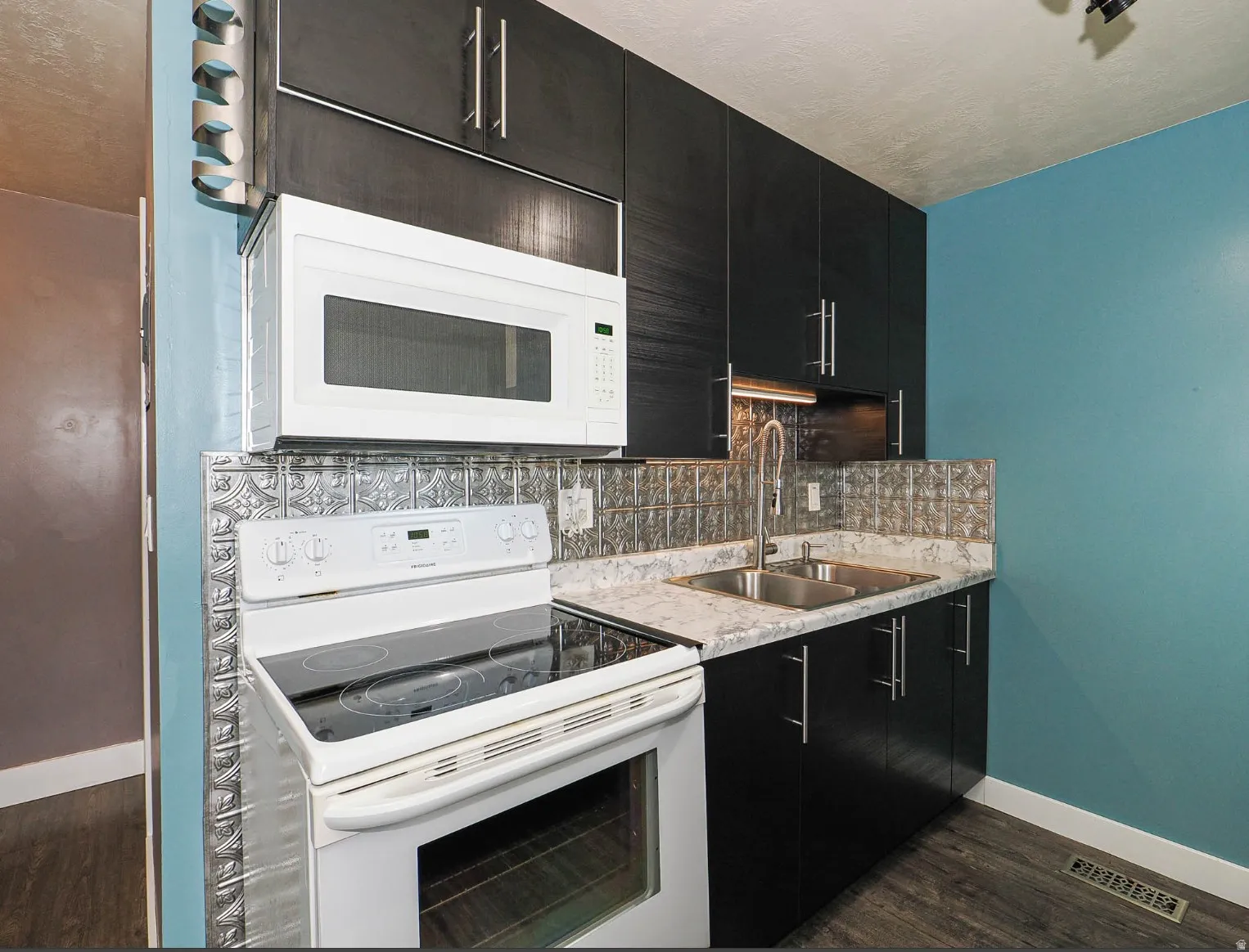 New large stainless steel sink with high end faucet. New microwave, garbage disposal and kitchen plumbing