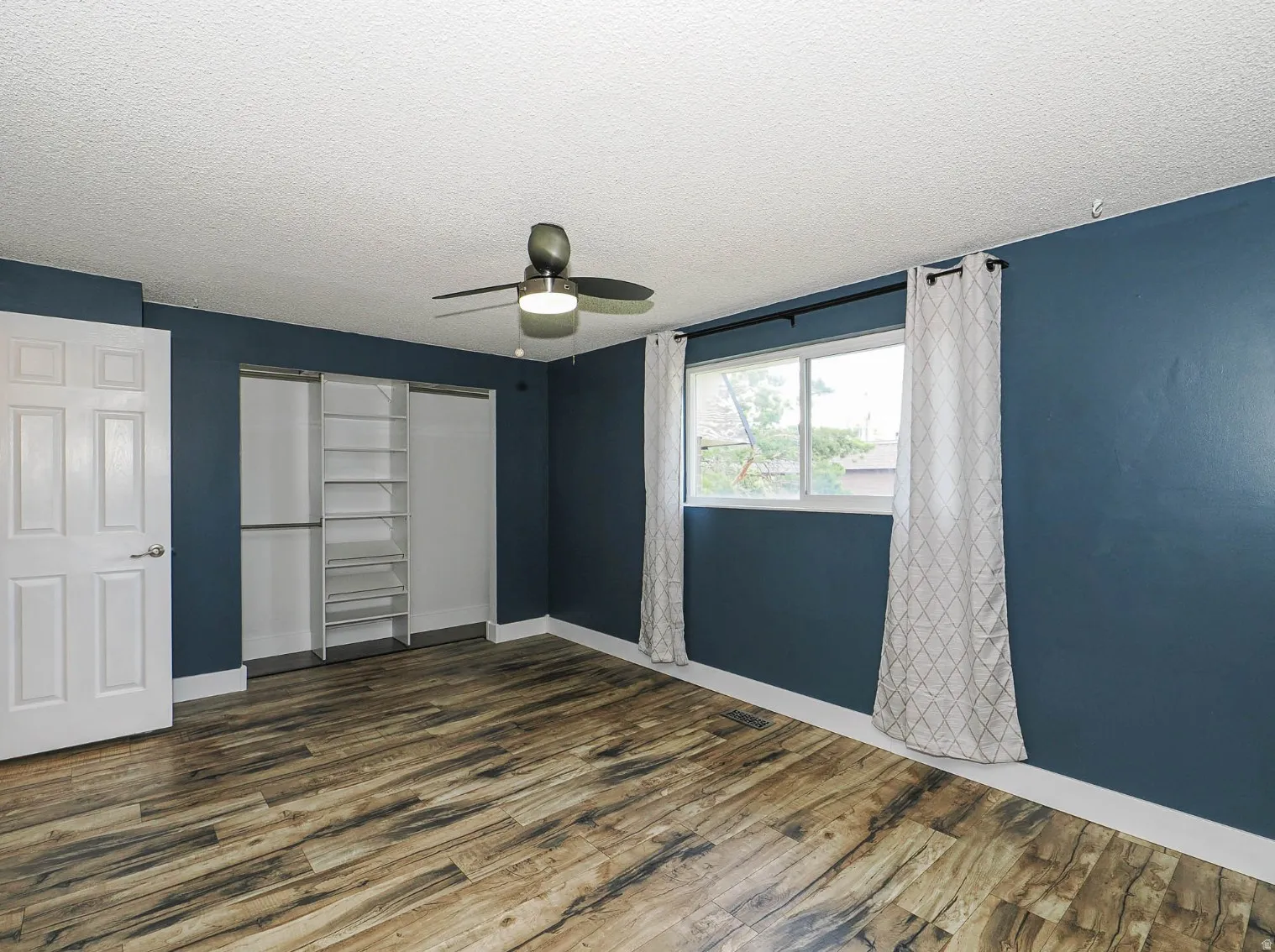 Bedroom with 2 tone paint and ceiling fan
