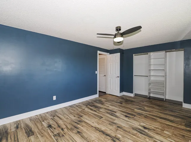 LVP flooring  and organized closet in bedroom