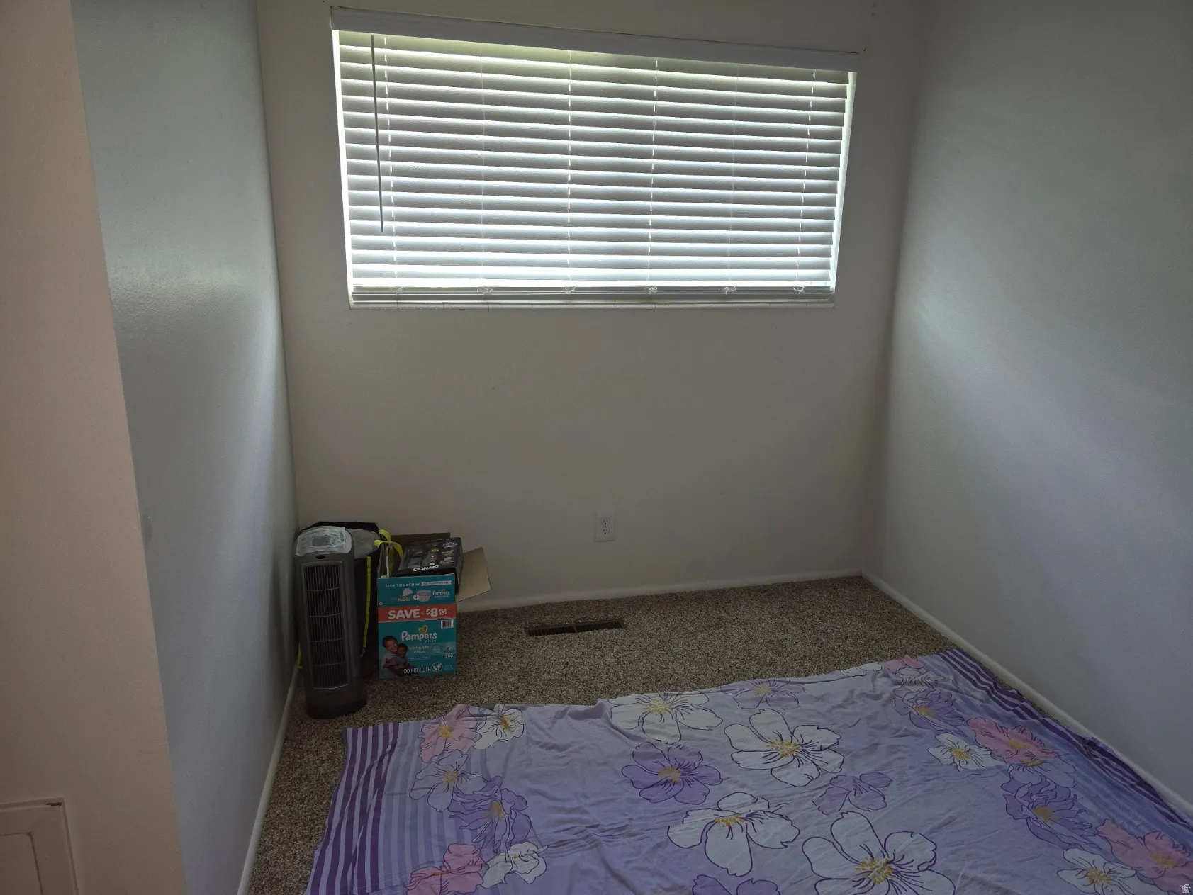 Room featuring neutral wall tones, window with horizontal blinds, and carpeted flooring