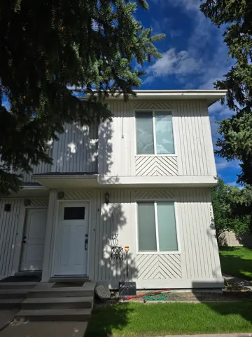 Two-story exterior with vertical siding and geometric decorative paneling