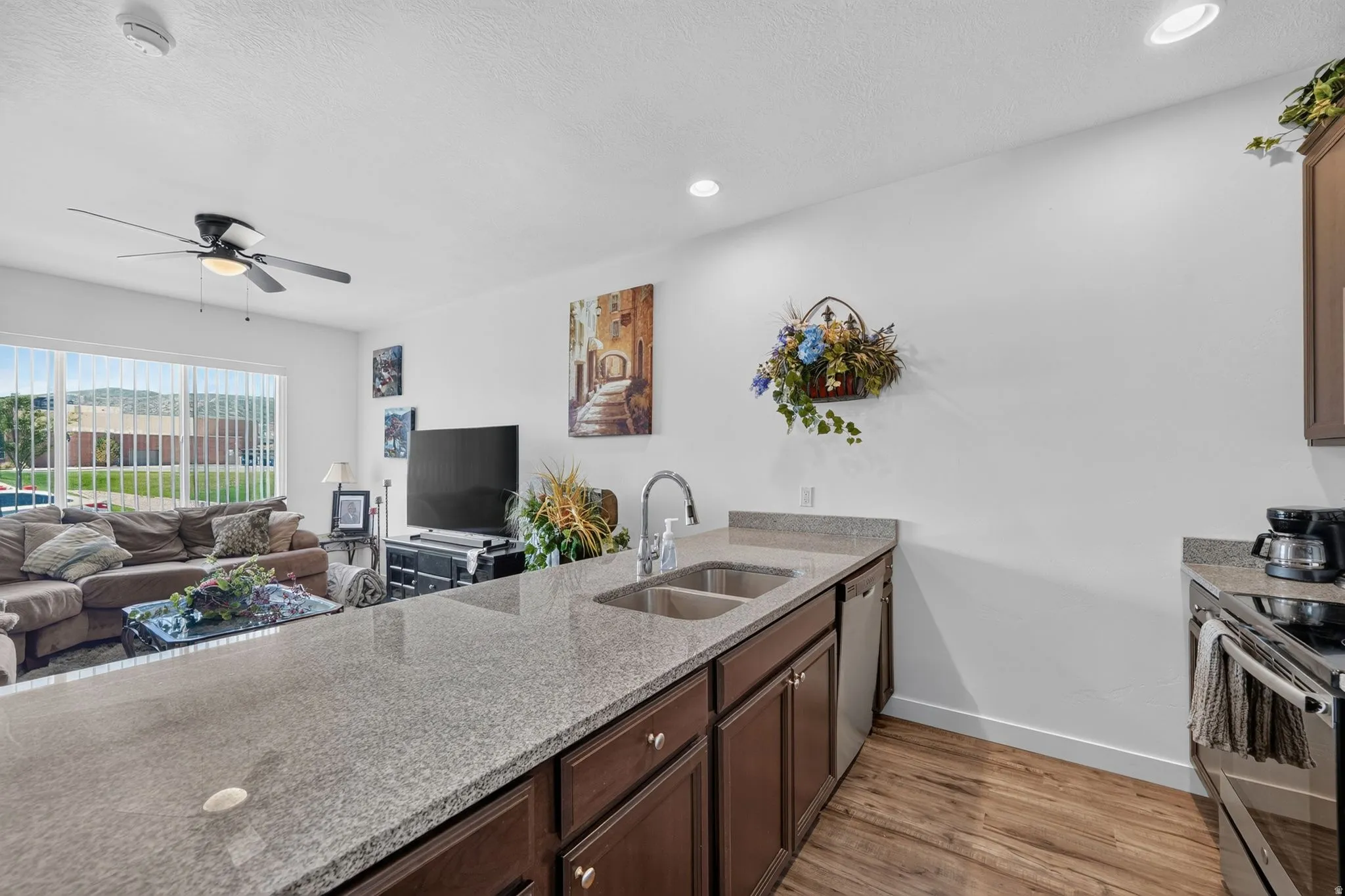 Kitchen island with a double basin stainless steel sink and a stainless steel dishwasher