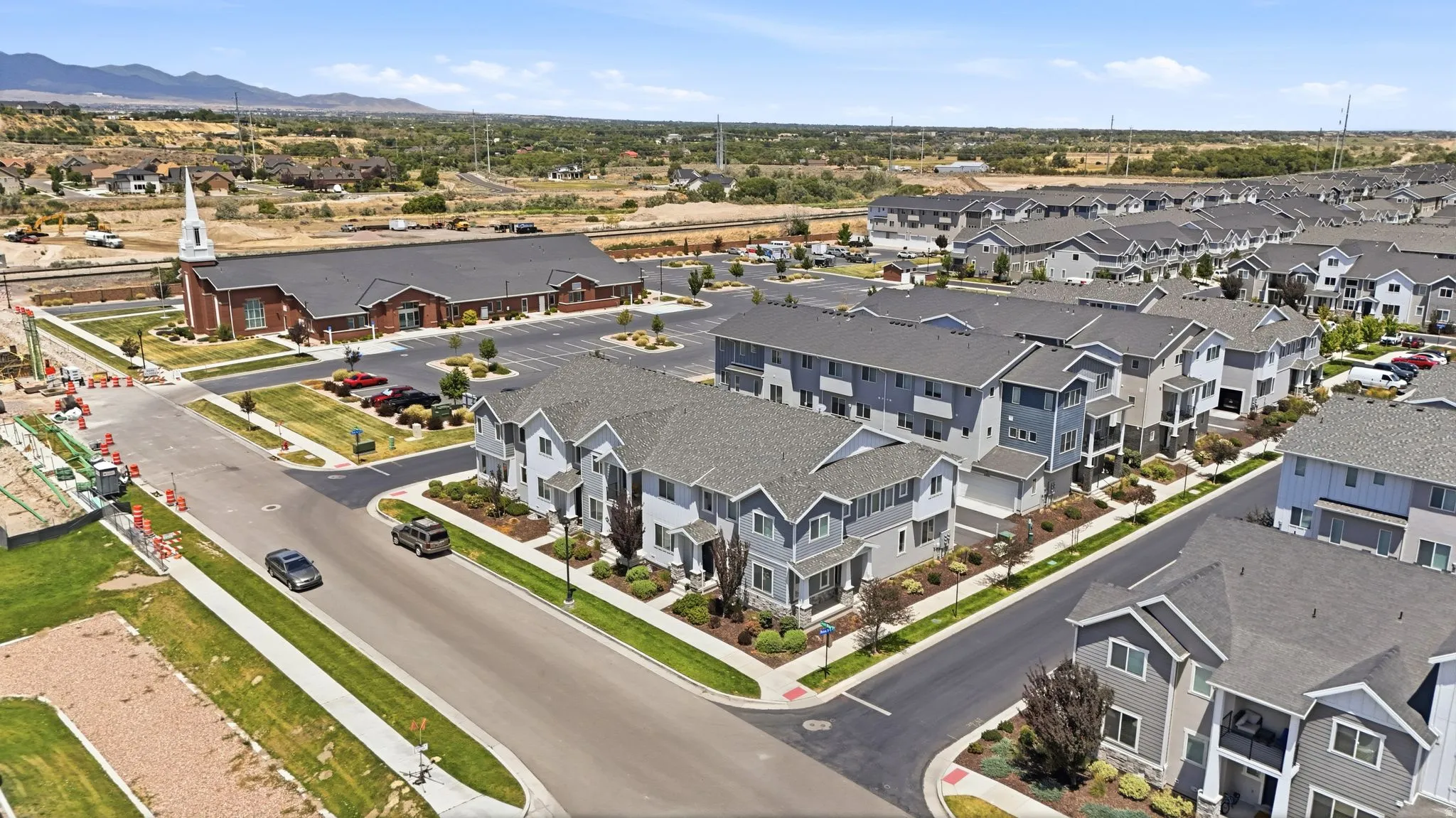 Newly constructed townhome community featuring diverse architectural styles and gray roofing