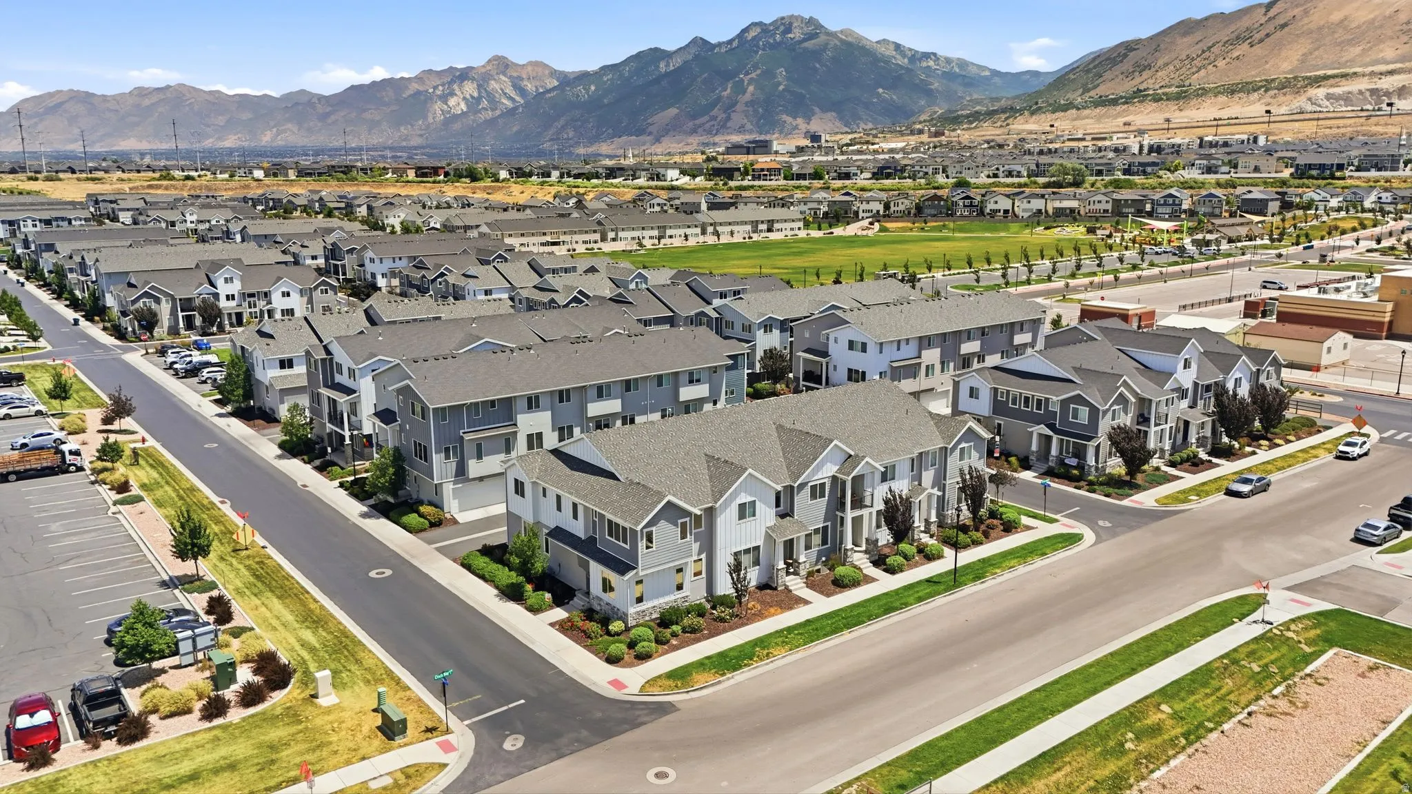 Expansive community of multi-story residences featuring gray siding, white trim, and dark gray roofing