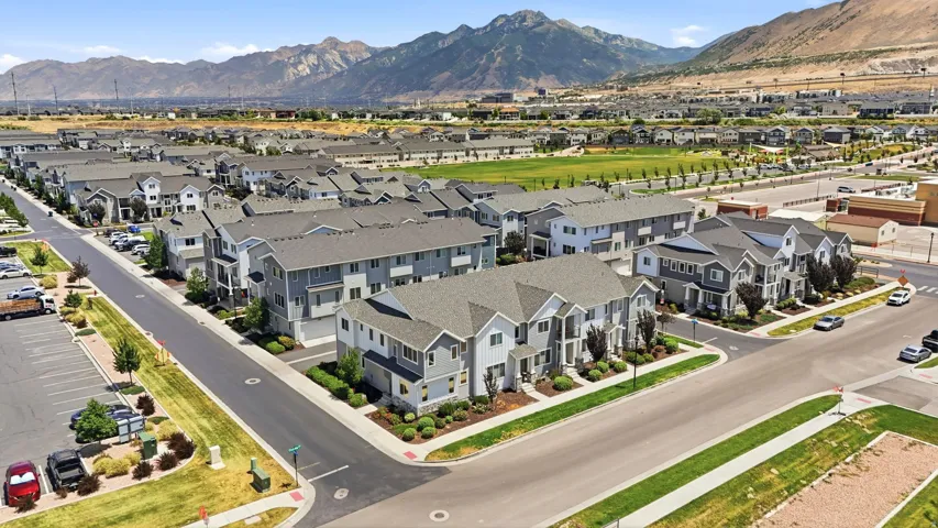 Expansive community of multi-story residences featuring gray siding, white trim, and dark gray roofing