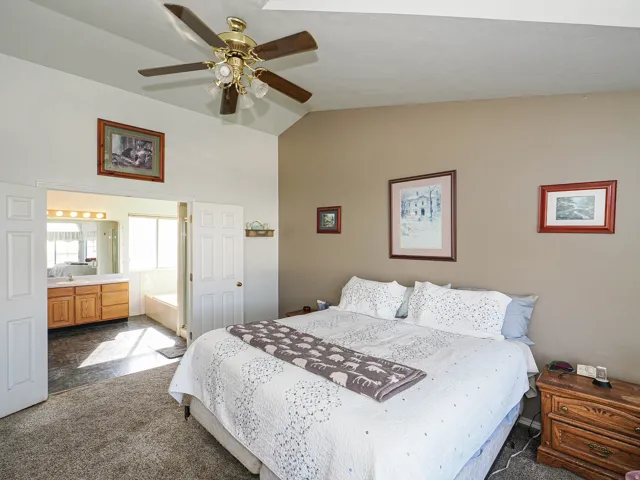 Vaulted ceiling room with ceiling fan light fixture