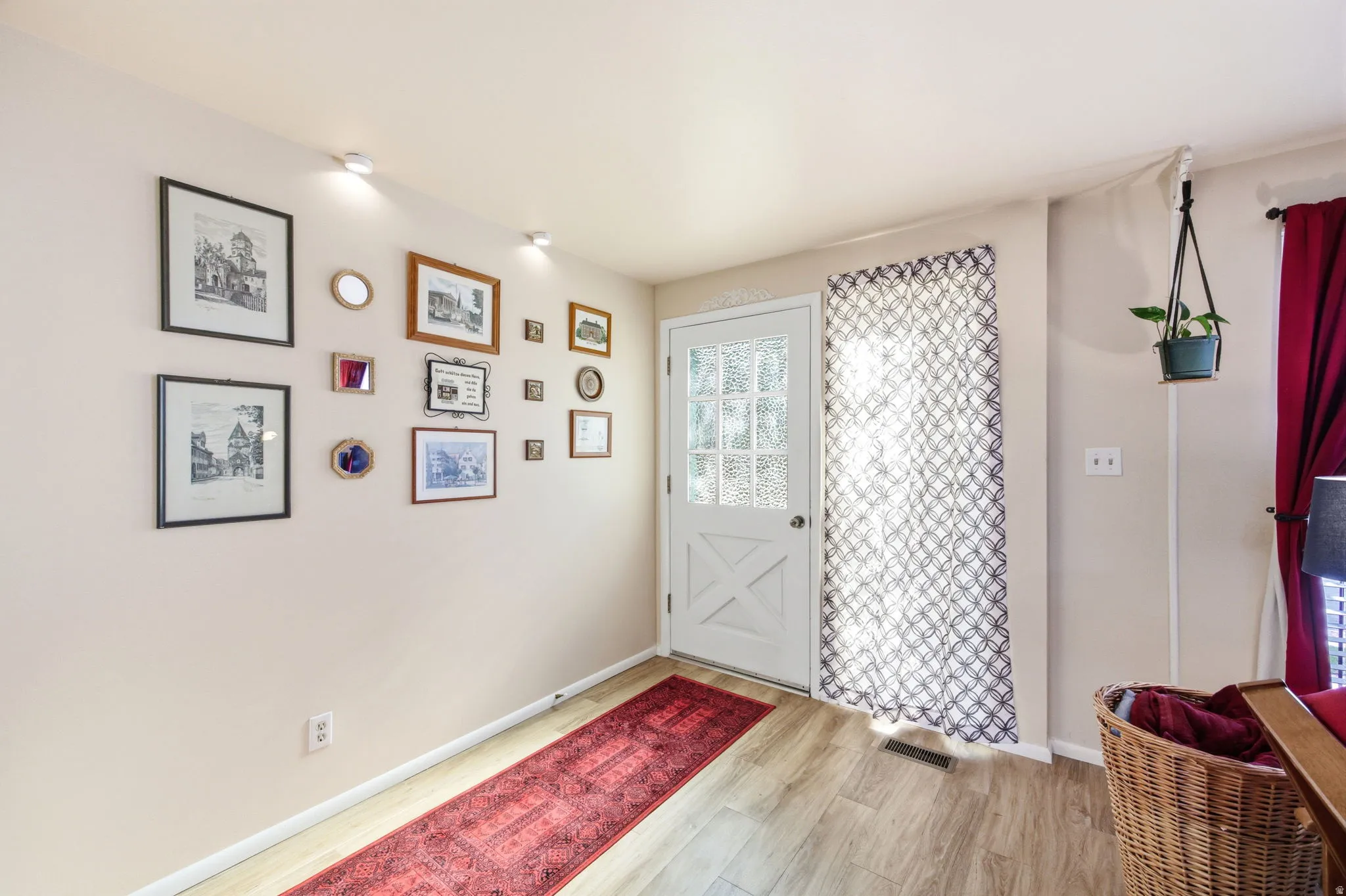 Entryway featuring wood-finish flooring, a glass-paneled door with an X-brace design, and recessed ceiling lighting