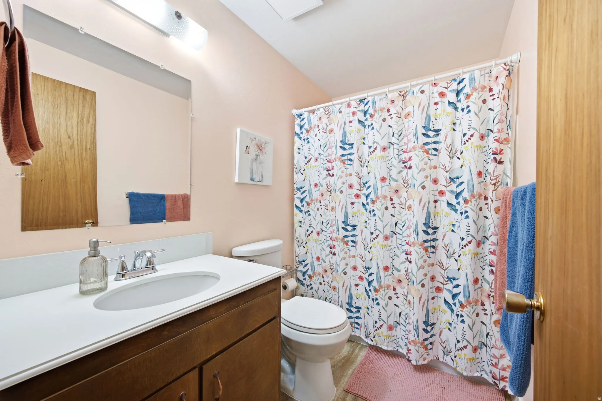 Full bathroom featuring a single vanity with a white countertop and dark wood-finish cabinetry