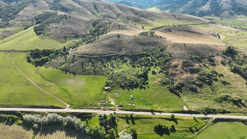 Expansive landscape featuring rolling hills and abundant green acreage