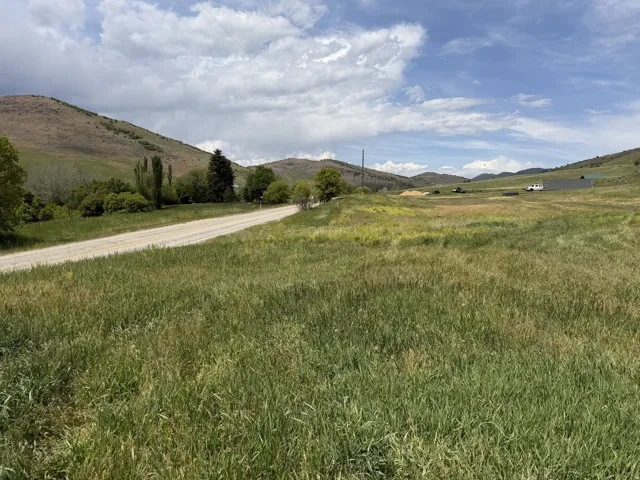 Expansive land parcel featuring open fields and distant hills