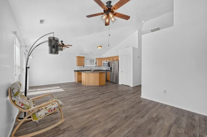 Vaulted ceilings above wood-finish flooring in an open-concept living area