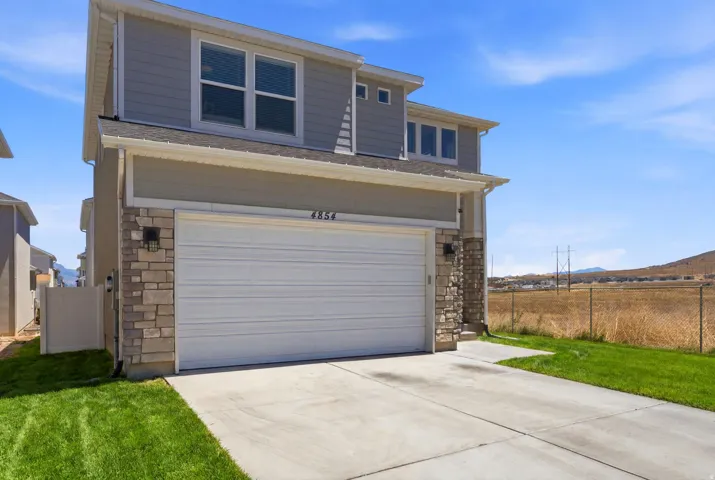 No neighbors to the South.  Contemporary facade featuring light gray siding and stone accents