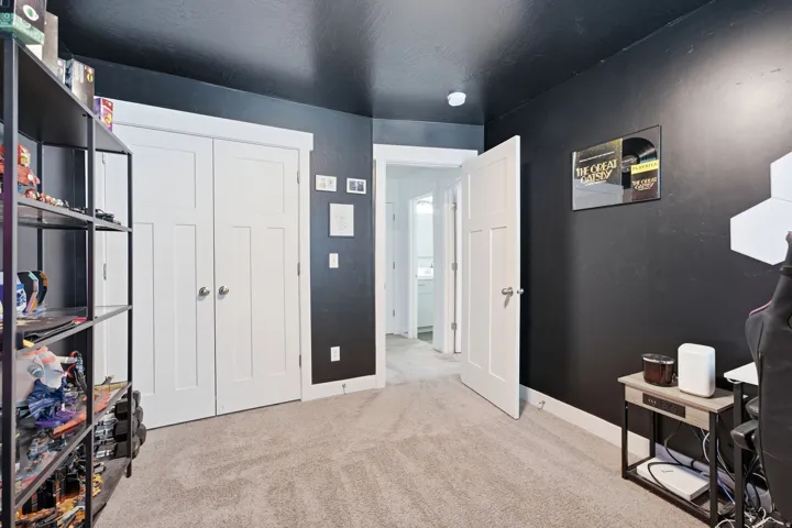 Room with Tricorn Black walls and ceiling, featuring white trim and white paneled doors