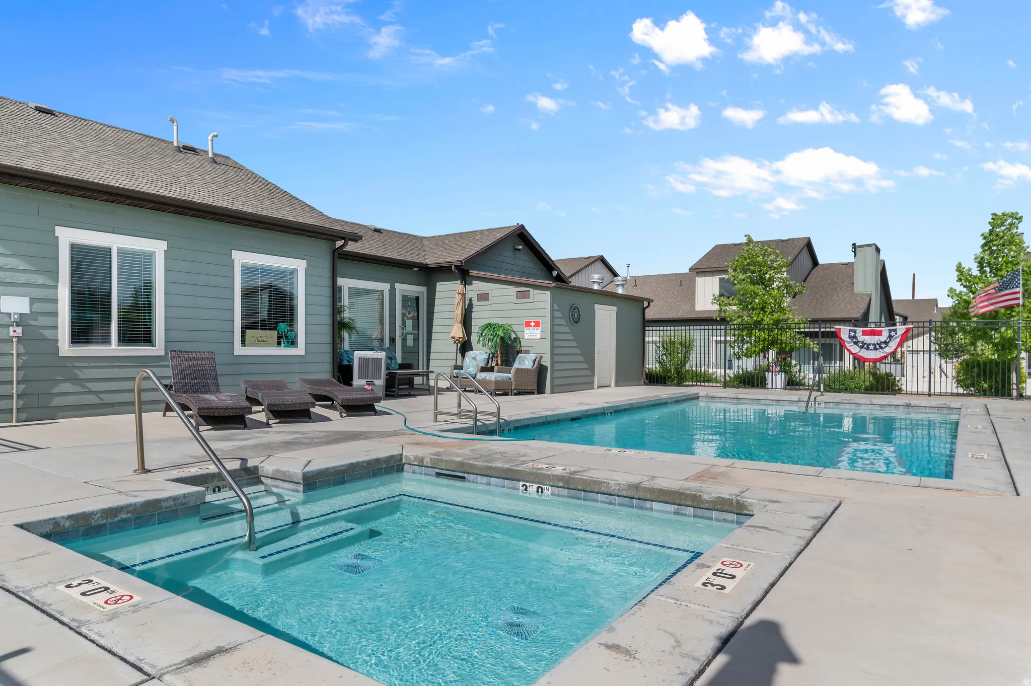 Outdoor swimming pool and spa area with concrete decking