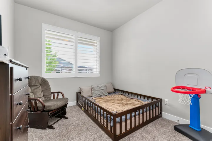 Room featuring neutral wall tones and textured carpeting