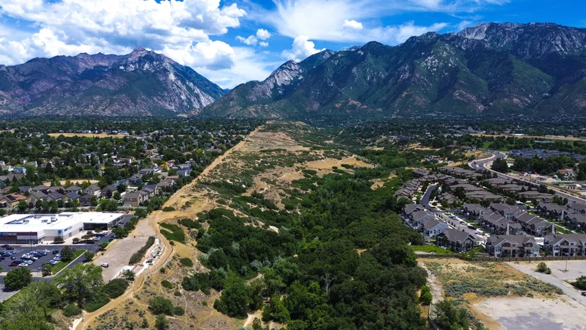 Expansive mountain backdrop framing a residential area with varied housing styles