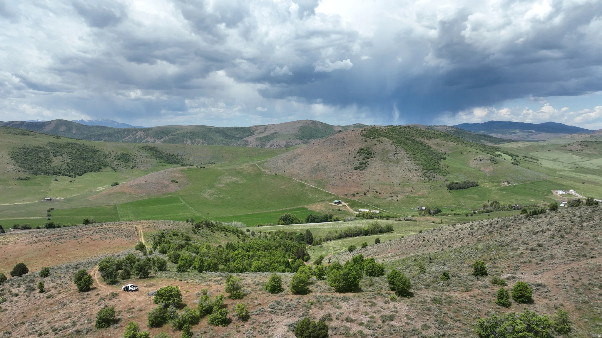 Expansive natural landscape featuring rolling hills and distant mountains