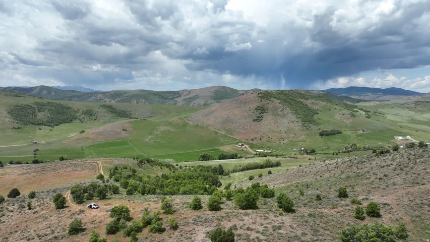 Expansive natural landscape featuring rolling hills and distant mountains
