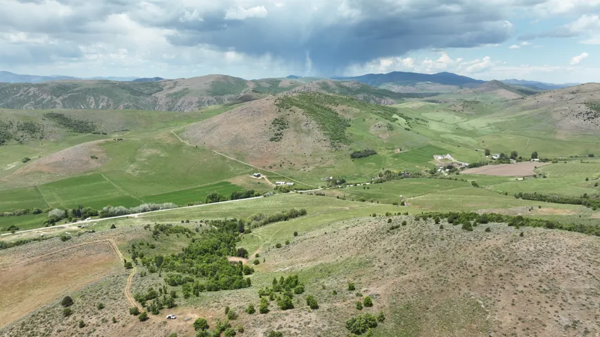 Expansive rural landscape featuring rolling hills, varied topography, and verdant fields
