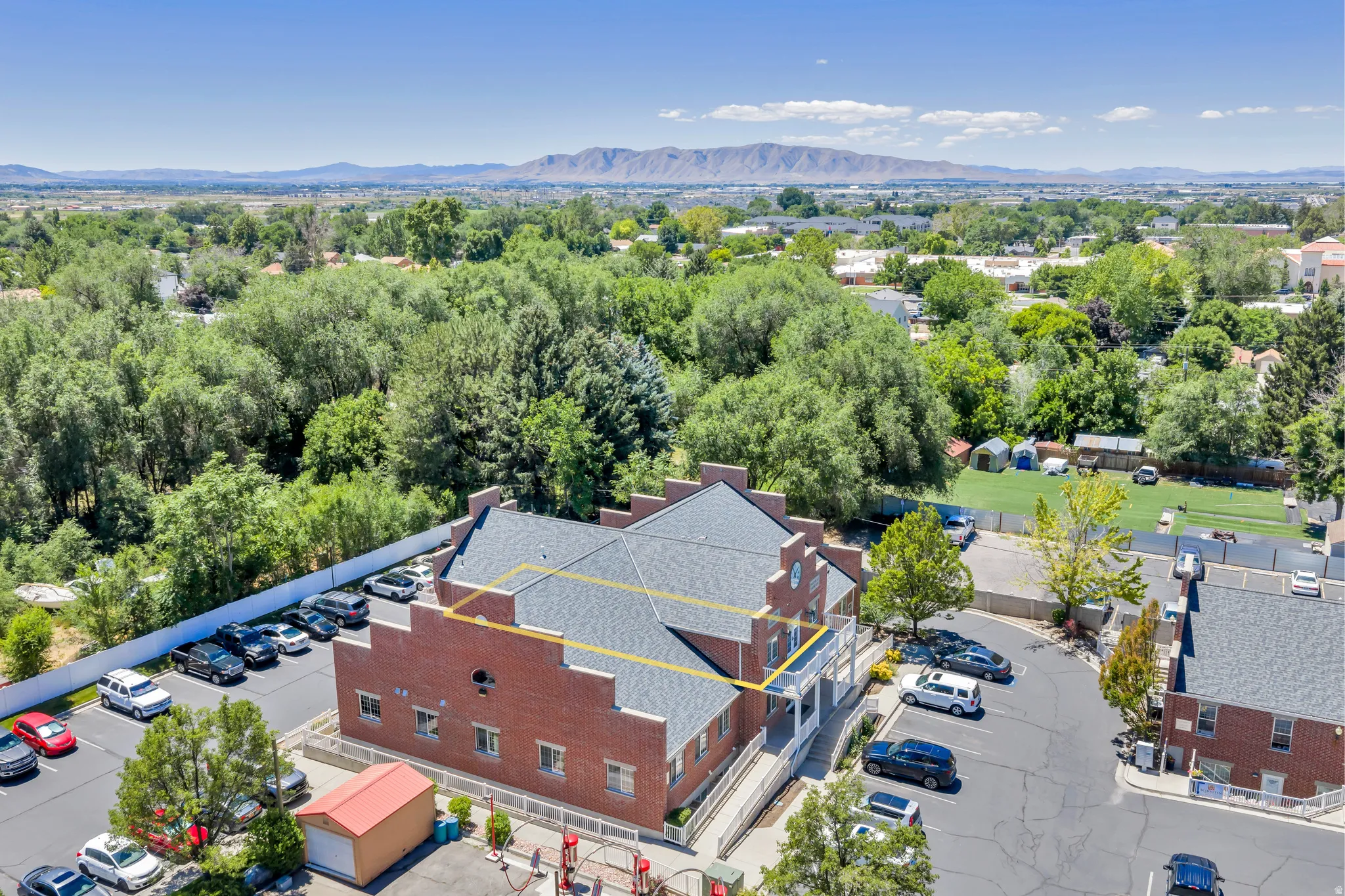 Brick commercial building with multiple parking areas and a large, flat roof