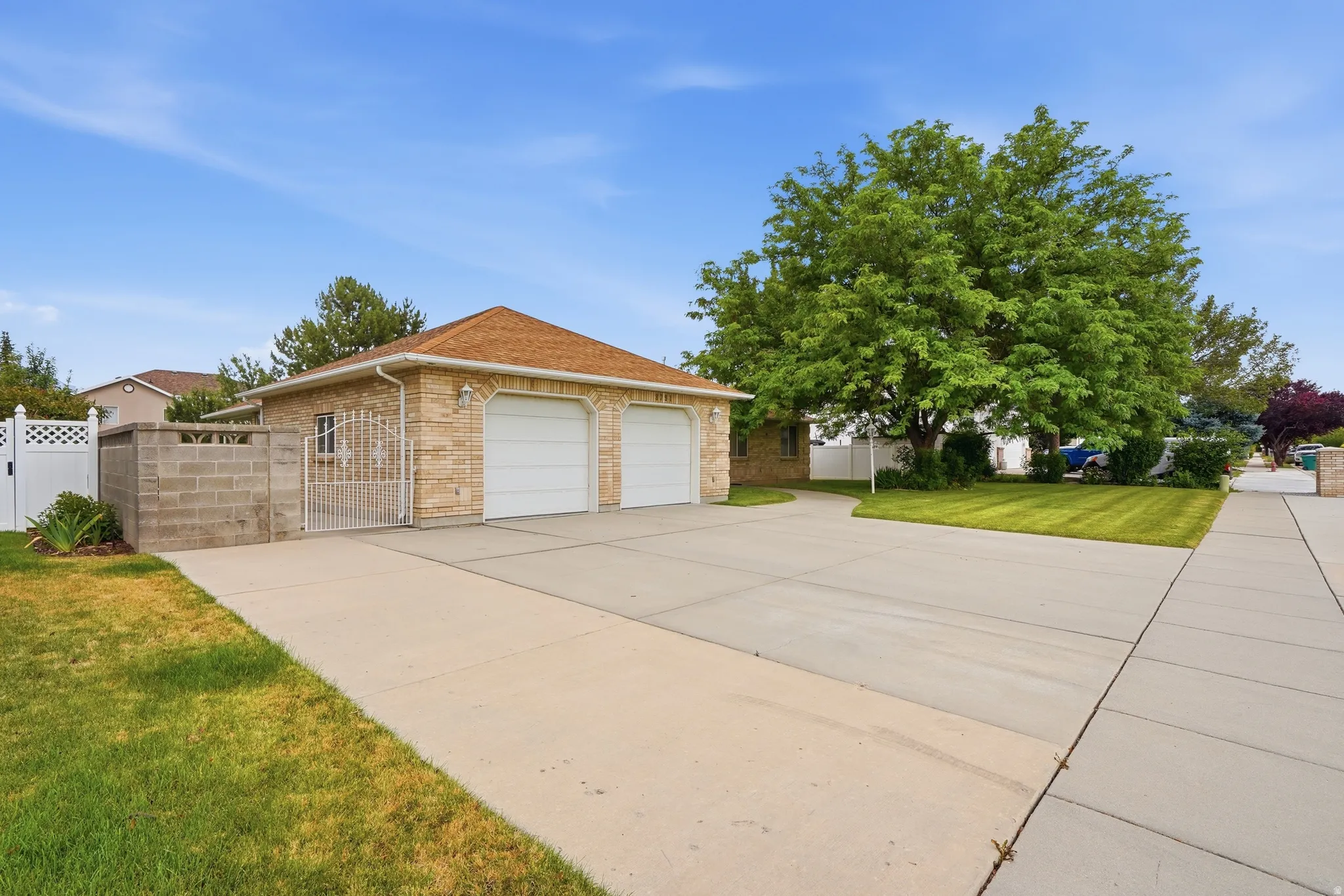 Attached extra wide two-car garage and white garage doors