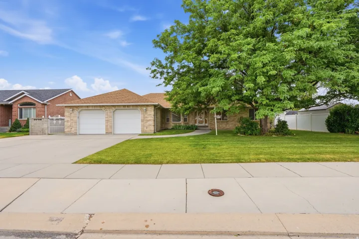 Desirable full brick rambler featuring an attached two-car garage